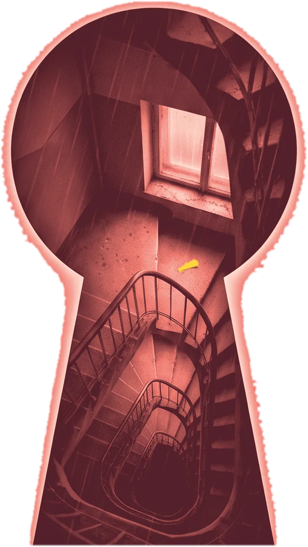 A keyhole looking down a spiral stairwell, a small yellow hair clip on one step